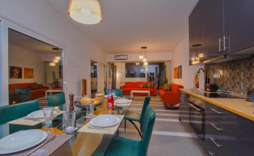 a kitchen and living room with a table and chairs at Villa Elpiniki in Ixia