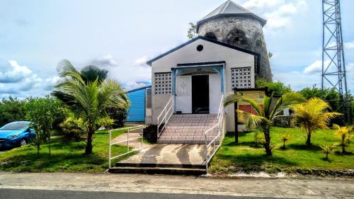 a small white church with a tower at villa siber in Port-Louis