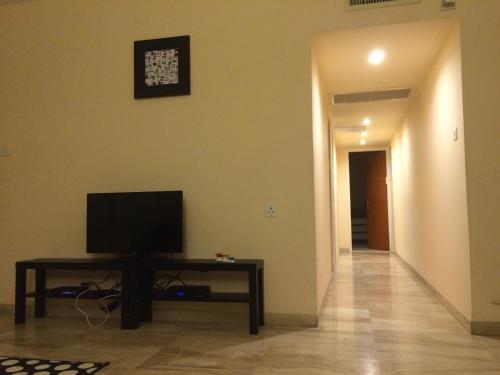 a living room with a television on a table at Apartment on Nitza 8a in Netanya