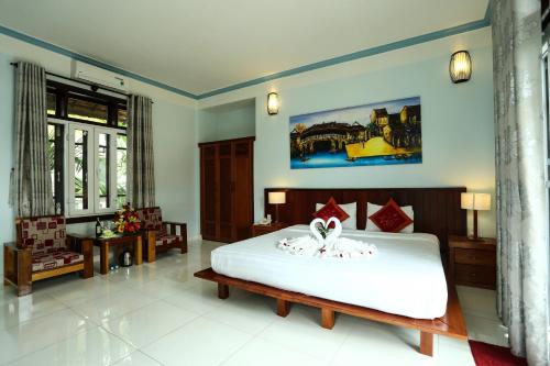 Giường trong phòng chung tại Hoi An Holiday Villa