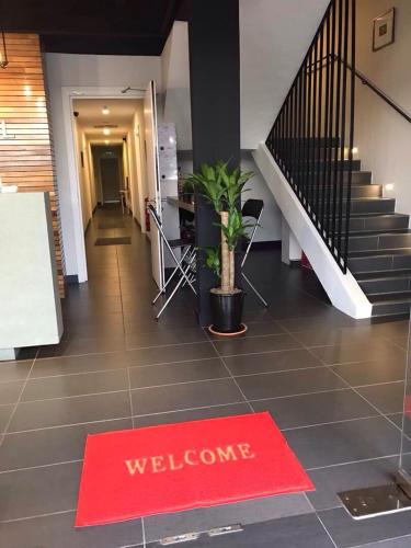 a welcome mat on the floor of a building with a staircase at MAX Hotel Subang Jaya in Subang Jaya