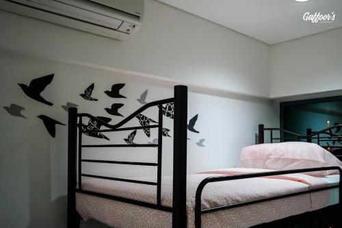 a bedroom with a bunk bed with bats on the wall at Resort Hostel In City in Kuala Lumpur