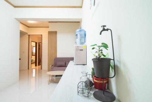 a kitchen counter with a plant and a refrigerator at Travel Friends in Huxi