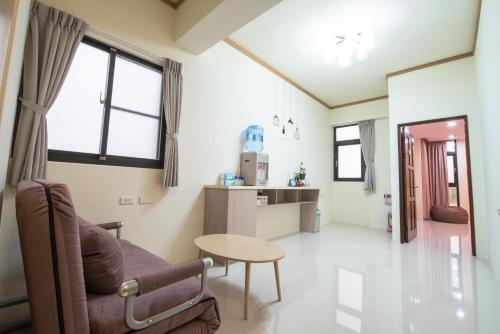 a living room with a couch and a table at Travel Friends in Huxi