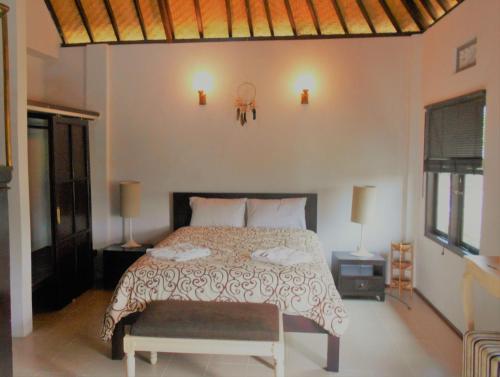 A bed or beds in a room at Shangrilah Villas