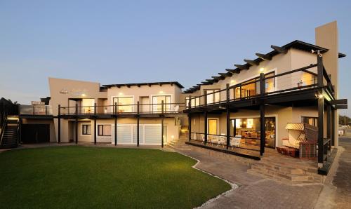 a large house with a lawn in front of it at Oyster Box Guesthouse in Walvis Bay