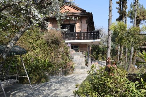 a house on a hill with a walkway at The Fort Resort in Nagarkot