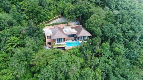 an aerial view of a house in the middle of a forest at Korsiri Villas in Panwa Beach