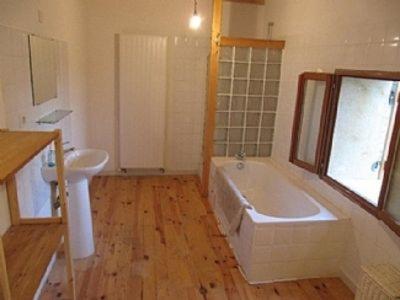 a bathroom with a large tub and a sink at Le Petite Grange Gite in Sos