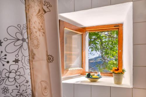 a window with a bowl of fruit on a window sill at Casa La Fragua in Capileira