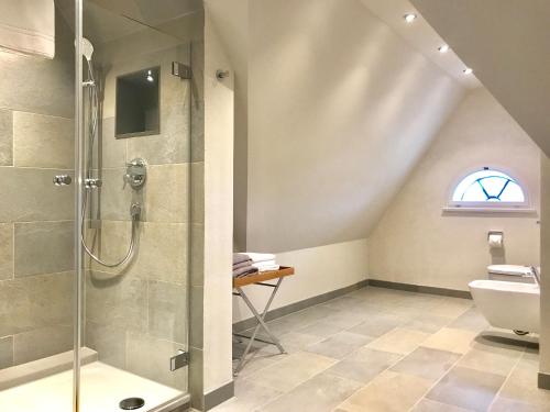 a bathroom with a shower and a toilet at Kleiner Ulenhof in Wenningstedt