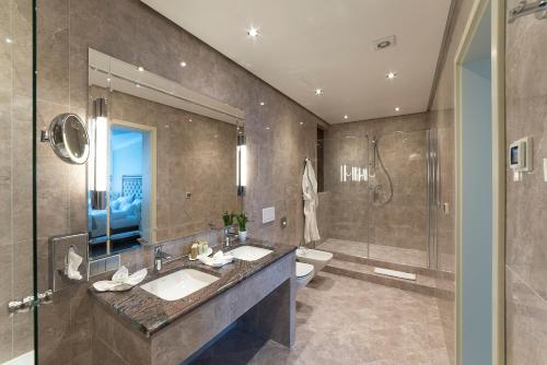a bathroom with two sinks and a shower at Park Hotel & Spa Katharina in Badenweiler
