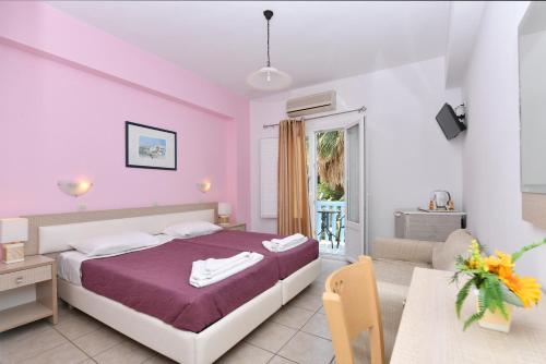 a bedroom with a bed and a desk and a table at Villa Katerina in Parikia