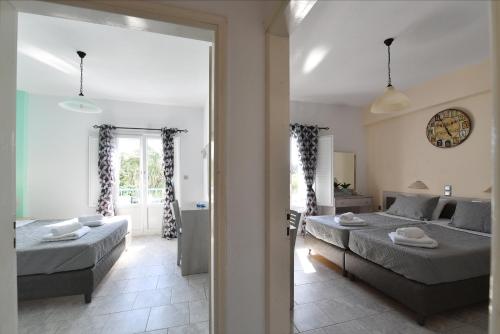 a bedroom with two beds and a living room at Villa Katerina in Parikia