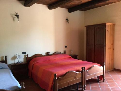 a bedroom with a large bed with a red blanket at La Fonte in Sala Consilina