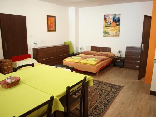 a room with two beds and two tables in it at Apartmány Mia in Kežmarok