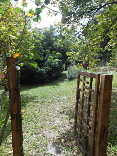 a wooden gate in a field with trees and grass at Le Havre Gourmand in Rodrigues Island