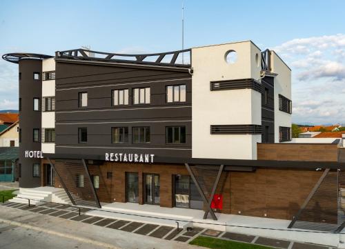 a building with a black and white facade at Hotel Ideo Lux in Niš