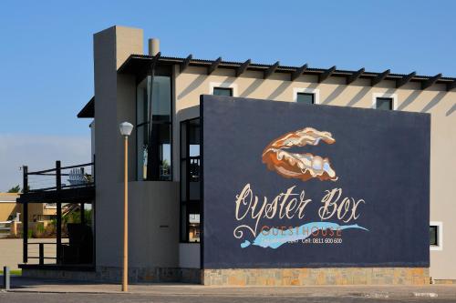 a building with a sign on the side of it at Oyster Box Guesthouse in Walvis Bay
