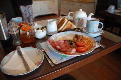 a table with a plate of food and a plate of food at Armada Guesthouse in Redcar