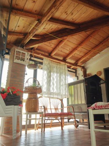 a room with a table and chairs and a wooden ceiling at Dai Nonni, B&B a Chieti in Chieti