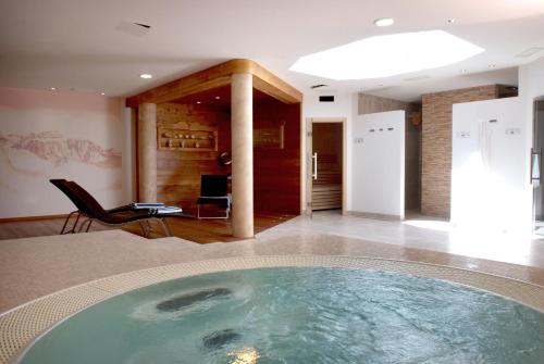 a large swimming pool in the middle of a room at Agritur Maso Chemela in Cavalese