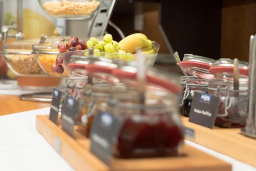 a display of fruit in glass jars on a counter at Landgasthof Zum Stern in Hammelburg- Obererthal