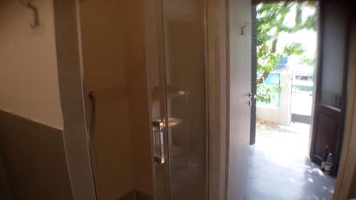 a glass door leading into a room with a door at Casa Martini in Mogliano Veneto