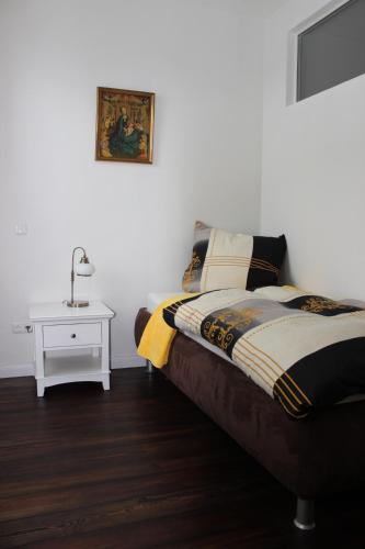 - une chambre avec un lit et une table avec une lampe dans l'établissement Ferienwohnung Westwind, à Schüller