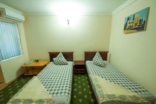 En eller flere senge i et værelse på Hotel Nasriddin Navruz
