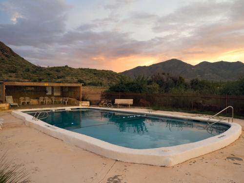 a large swimming pool with mountains in the background at Terlingua Ranch Lodge in Terlingua