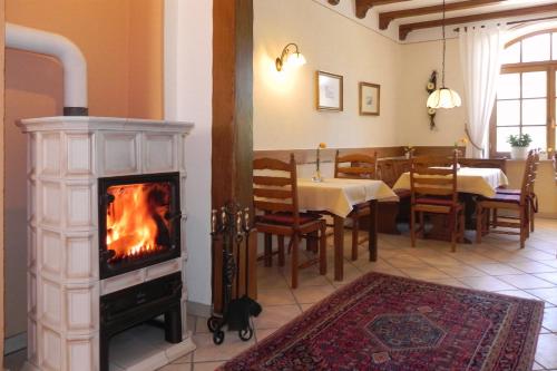 a living room with a fireplace and a dining room with a table at Ferienhaus Erich Bremm mit Moselblick in Neef