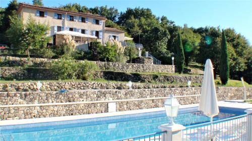 a swimming pool with a house and a building at B&B with charm, quiet, kitchen, sw pool. in Grasse