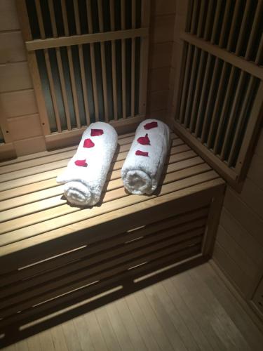two towels sitting on a bench in a sauna at Ly'Ove in Lyon