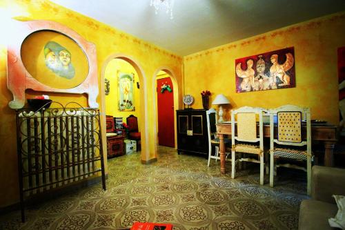 a living room with yellow walls and a table and chairs at Hand decorated house with court in Florence