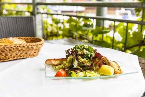 a plate of food on a table with a salad at Hotel Rheingold in Gernsheim