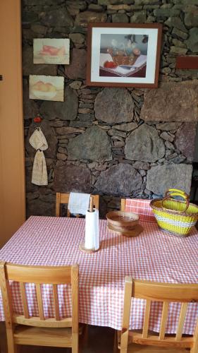 a table with a red and white checkered table cloth at Casa de piedra a 2 km de la Playa in La Aldea de San Nicolas