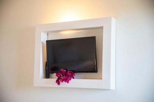 a flat screen tv in a white wall at Hotel Palau in Palau