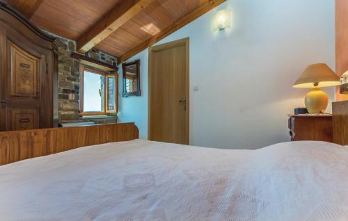 a bedroom with a large bed and a window at Apartment Anna in Draguć