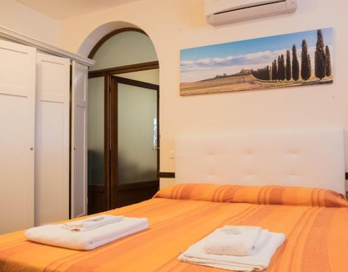 a bedroom with a bed with two towels on it at Apt Versilia in Viareggio