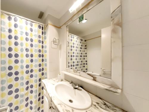 a bathroom with a sink and a mirror at Apartamentos Medano - Playa Grande in El Médano