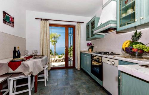 a kitchen with a dining table and a view of the ocean at Apartment Anika in Kostrena