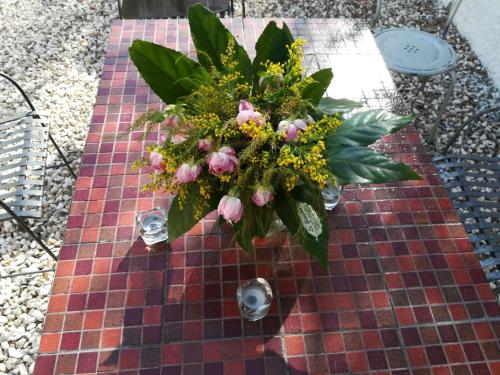 a vase of flowers sitting on a table at i girasoli srls in Bari