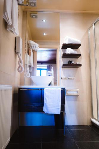 a bathroom with a sink and a counter with towels at Trikolonion Country Stemnitsa in Stemnitsa