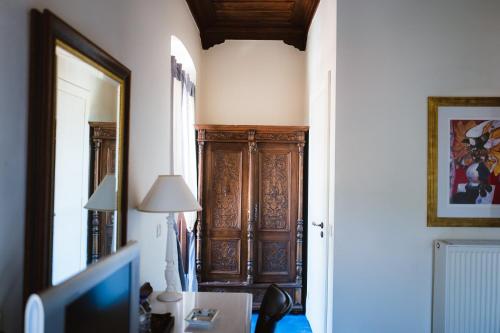 a hallway with a wooden cabinet in a room at Trikolonion Country Stemnitsa in Stemnitsa