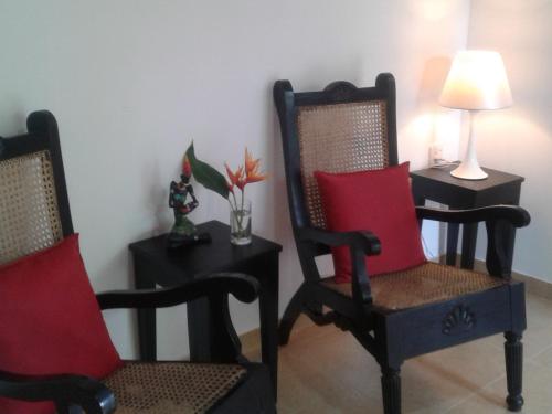 a room with two chairs and a table with a lamp at Anusha Apartment 15 Homestay in Galle