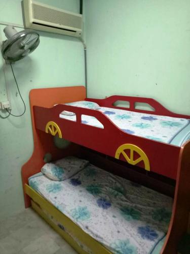 a bedroom with a bed with a car on it at Farzai Homestay in Lumut