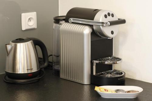 a kitchen counter with a coffee maker and a mixer at Bed&Bike Prachatice in Prachatice