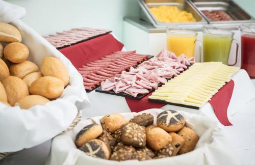 a table topped with lots of different types of food at Hotel Adria in Lignano Sabbiadoro