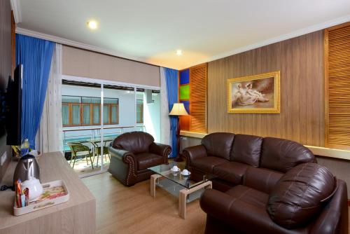 a living room with a couch and a table at Princess River Kwai Hotel in Kanchanaburi